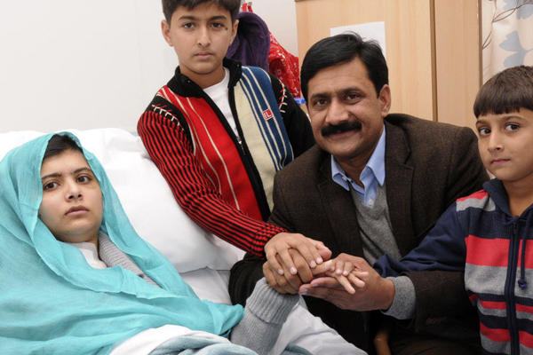 Malala with her father in the hospital (www.malala-yousafzai.com (unknown))